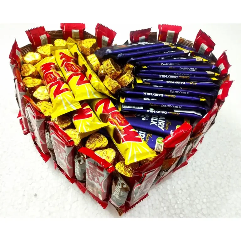 Full top-down view of a customized heart-shaped chocolate gift box filled with Dairy Milk, Now bars, gold hearts, and a Hiss chocolate border.