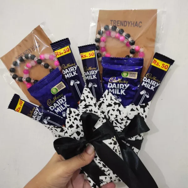 Side perspective view of the mini chocolate and bracelet gift package highlighting the black ribbon bow tie.