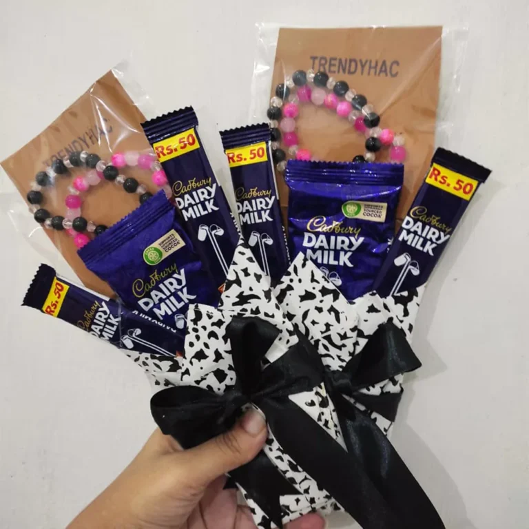 Side perspective view of the mini chocolate and bracelet gift package highlighting the black ribbon bow tie.