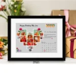 Front view of a black framed photo collage with a heart-shaped picture grid and a November calendar page on a grey background.