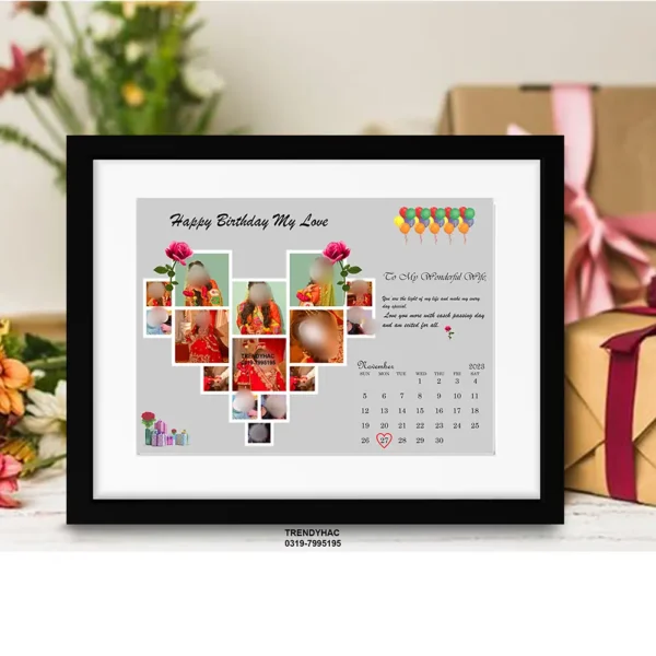 Front view of a black framed photo collage with a heart-shaped picture grid and a November calendar page on a grey background.