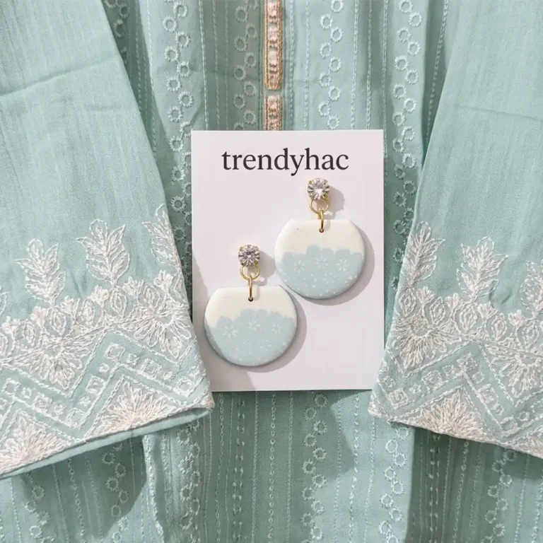 Half-circle mint green and white clay drop earrings with delicate floral embroidery details on a white trendyhac card, placed over a matching mint green chikankari dress.