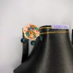 Close-up shot focusing on the sculpted gold roses, colorful pink and green leaves, miniature seed beads, and glossy resin protective topcoat.