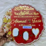 Handheld view of a circular red resin Nikah thumb board with gold calligraphy, names, pearl borders, and signing blocks.