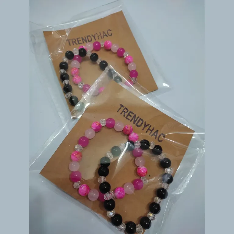 Top view of two packaged sets of handmade beaded bracelets featuring pink and black bead variations on Trendyhac kraft cards.