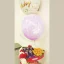 Full view of a heart-shaped chocolate gift basket with a purple happy birthday balloon inside a clear balloon dome.