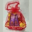Front view of a pink-themed chocolate gift basket with Cadbury Dairy Milk bars wrapped in red organza mesh.